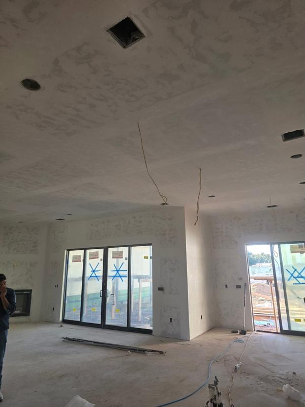 New home great room with drywall finished and patio doors in