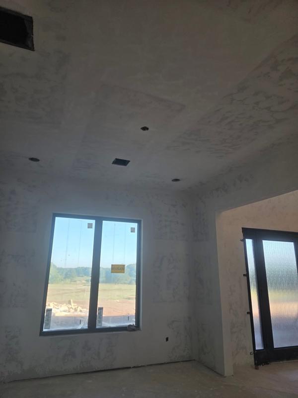 Bedroom drywall finished with a new window and door