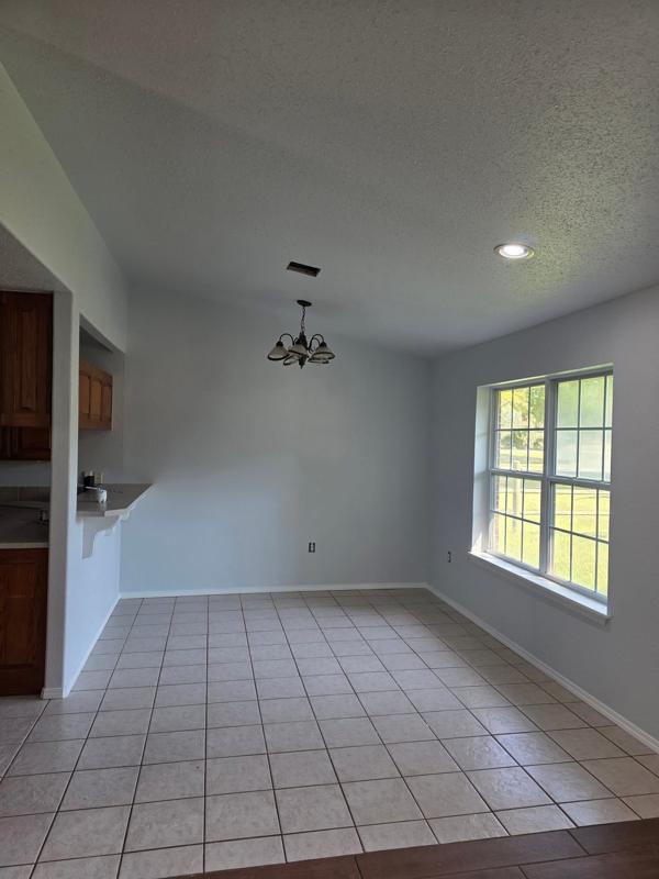 Remodeled kitchen and dining with new tile floor