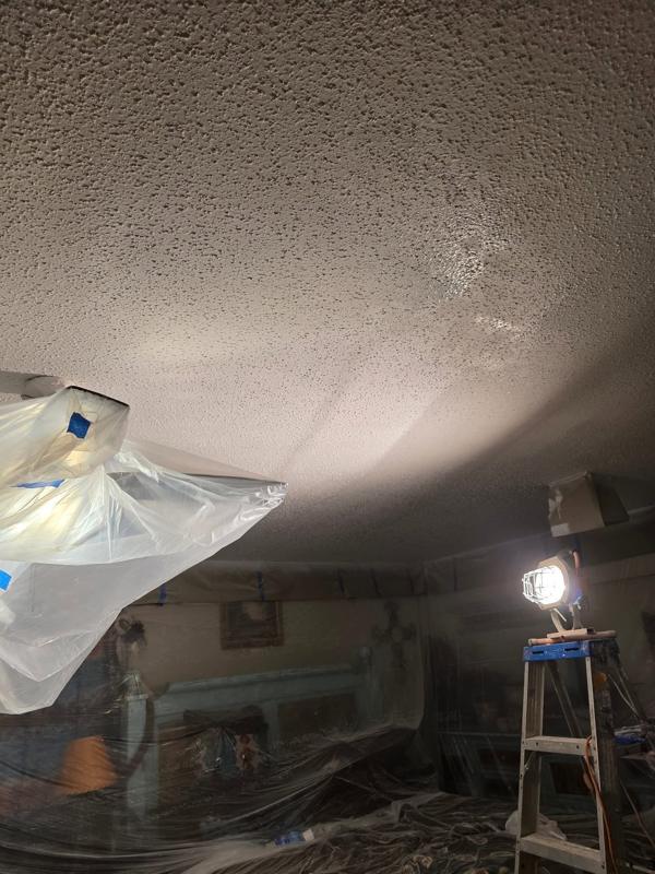 Room masked in plastic for ceiling work