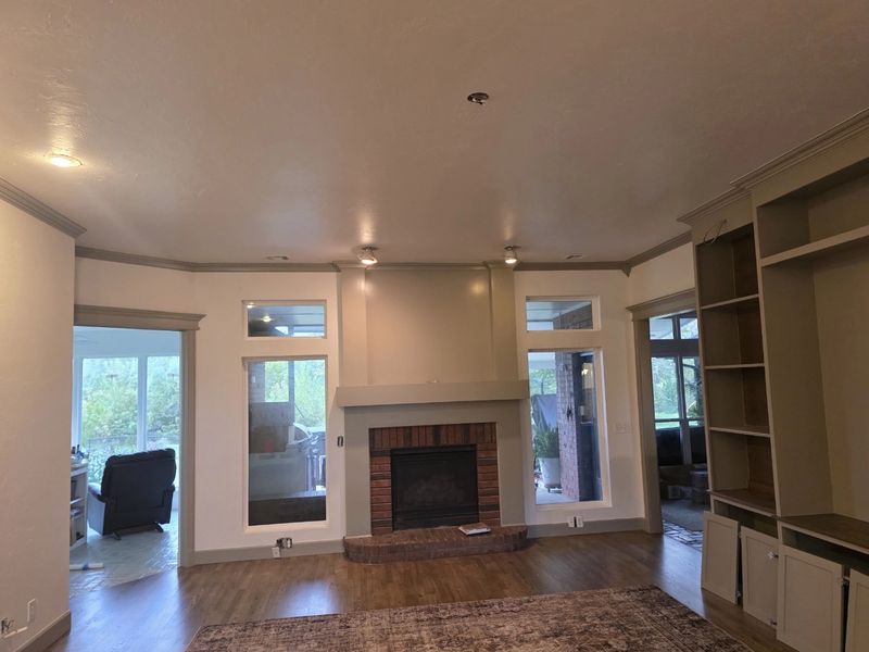 Fireplace wall with a painted surround and crown molding